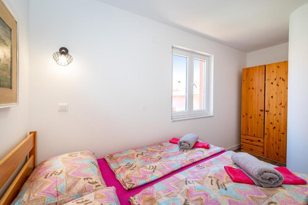Łóżko lub łóżka w pokoju w obiekcie Apartments Junior