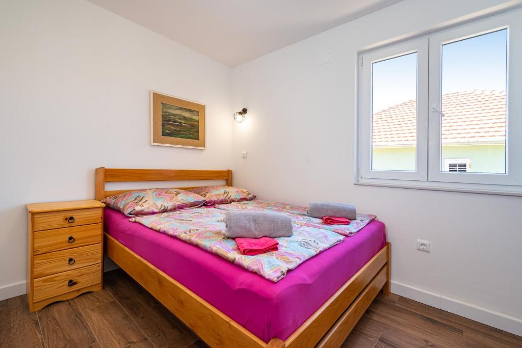 Łóżko lub łóżka w pokoju w obiekcie Apartments Junior