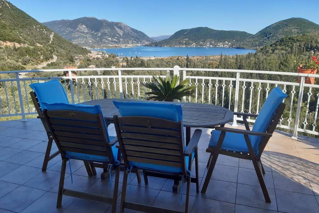 a table and chairs on a balcony with a view at Villa Sunrise with stunning views and private pool in Katokhórion