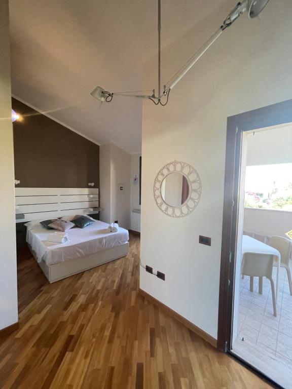 a bedroom with a bed and a dining room at Flamingo Poetto in Quartu SantʼElena