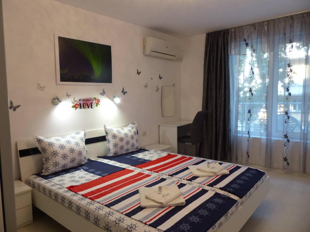 a small bedroom with a bed with avertisement for at Apartament HOLIDAY in Burgas City