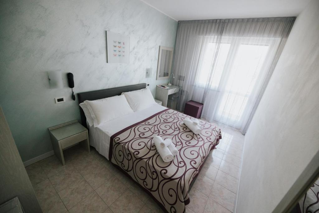 Posteľ alebo postele v izbe v ubytovaní Hotel Gloria