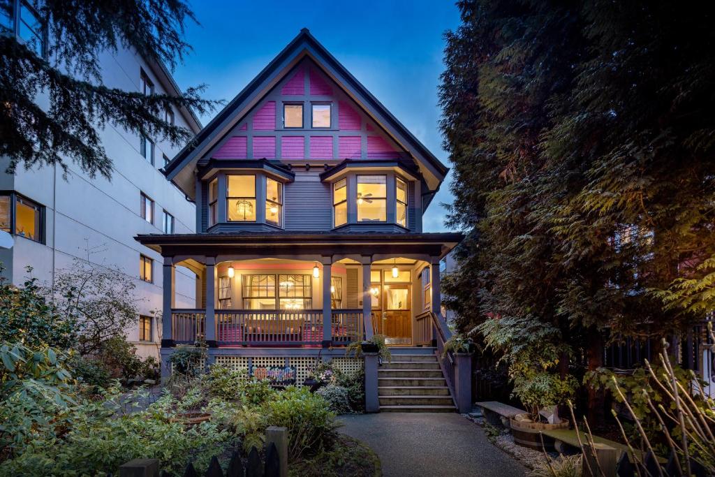 a large house with its lights on at West End Guest House in Vancouver