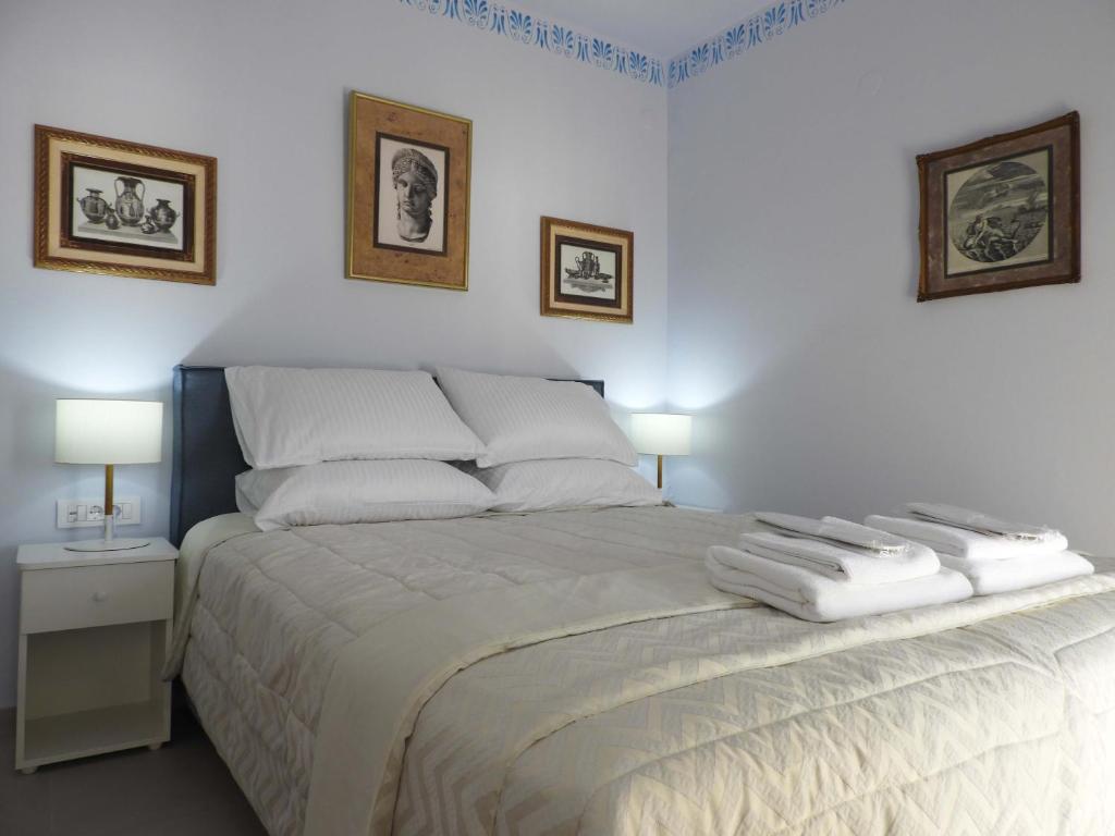 a bedroom with a bed with two towels on it at Flisvos sea view rooms in Parga