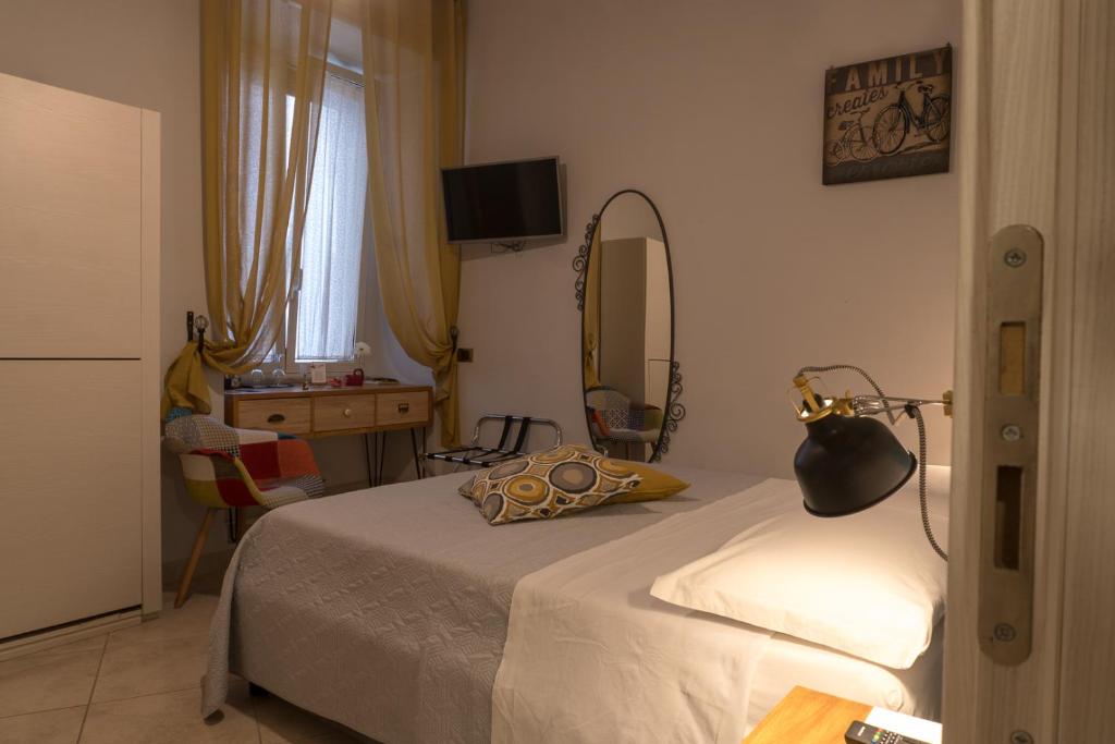 拿坡里的住宿－B&B Pantarei Napoli，一间卧室配有一张床、镜子和一张桌子