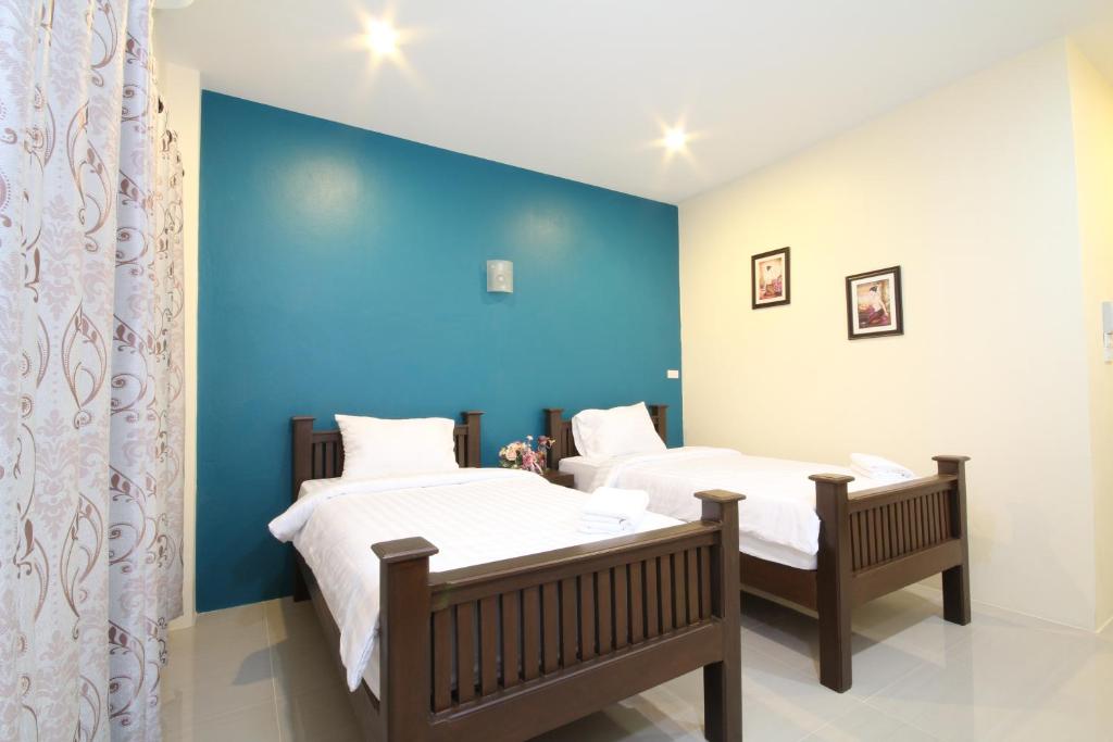 Postel nebo postele na pokoji v ubytování Blue House Sukhothai
