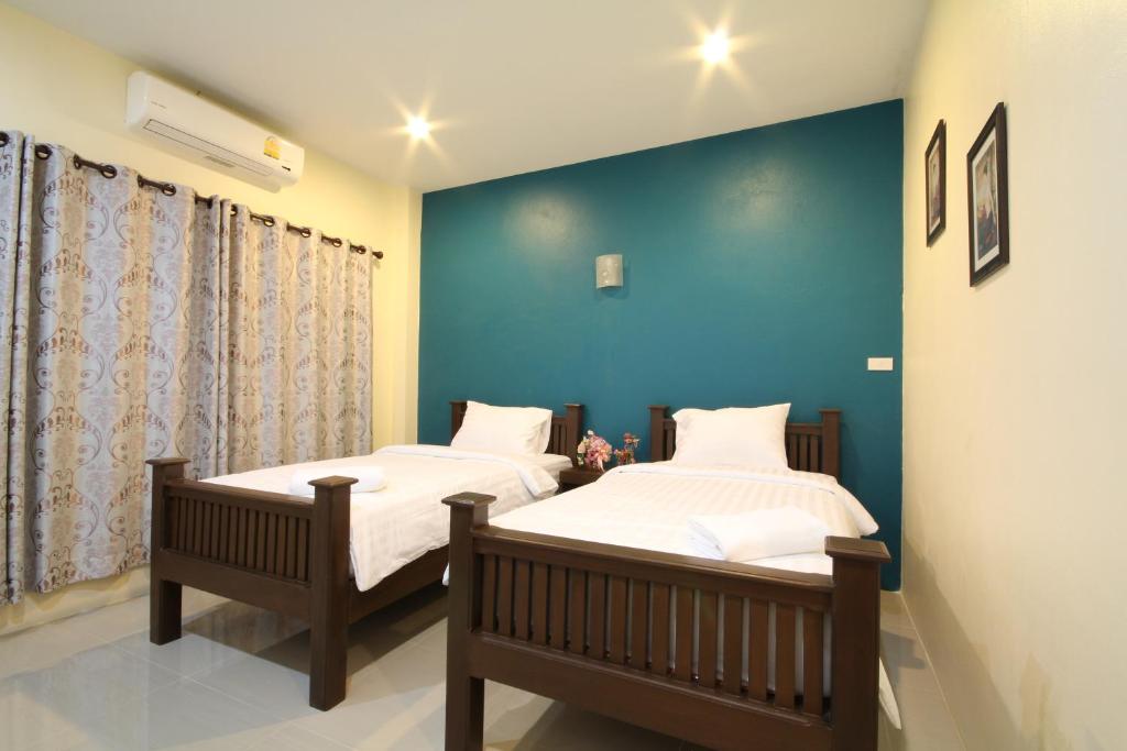 Postel nebo postele na pokoji v ubytování Blue House Sukhothai