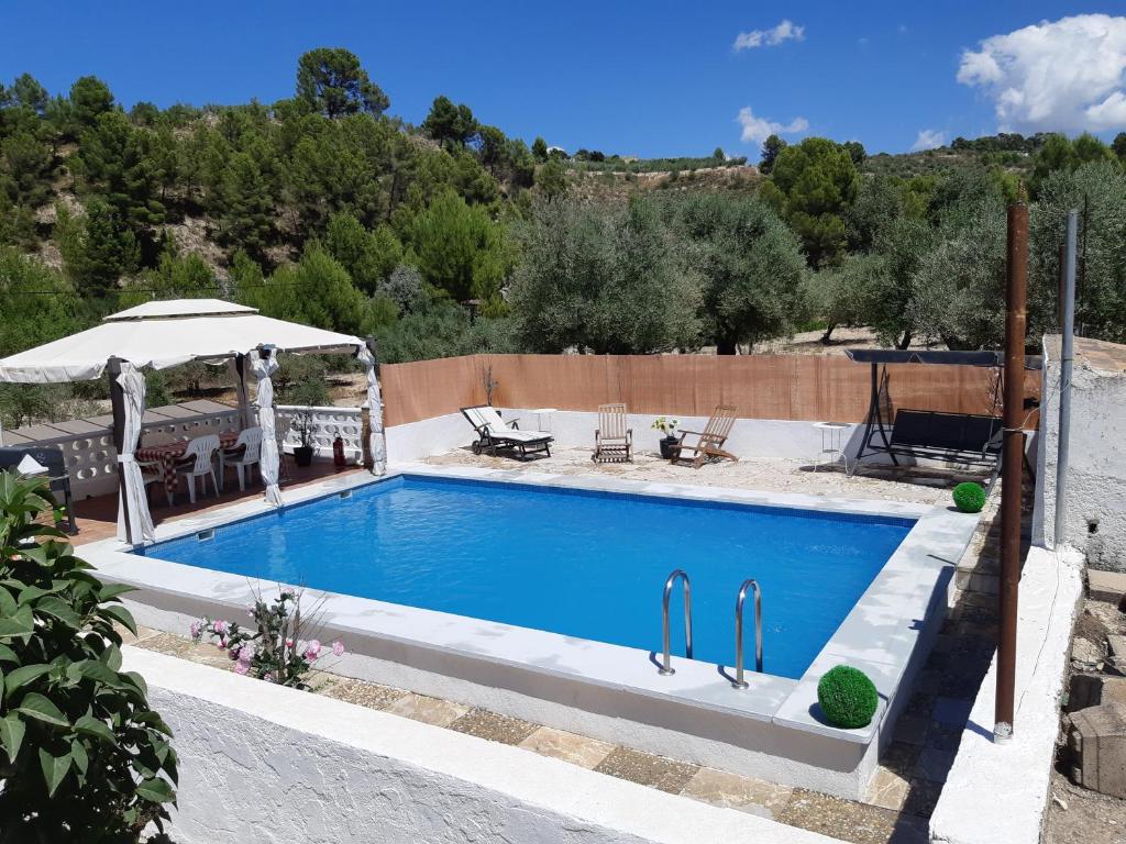 a swimming pool with a gazebo next to at Nice room with swimming pool in Cocentaina