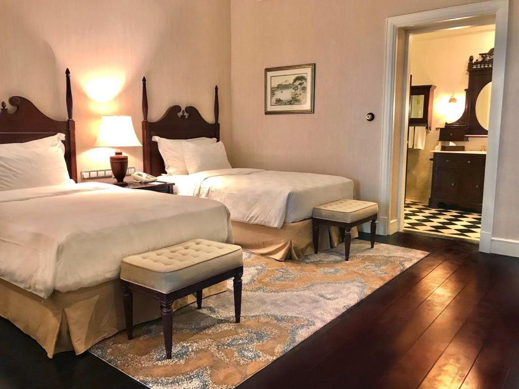 Postel nebo postele na pokoji v ubytování Hotel Majapahit Surabaya MGallery