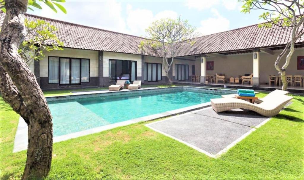 a swimming pool in the yard of a house at Bali Merita Villa in Canggu