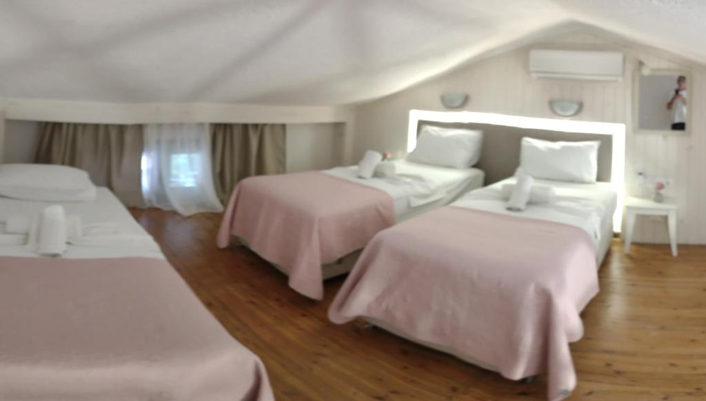 A bed or beds in a room at Irida Holiday Apartments