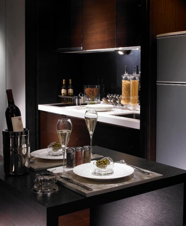 a kitchen with two plates of food and a refrigerator at Leofoo Residences in Taipei