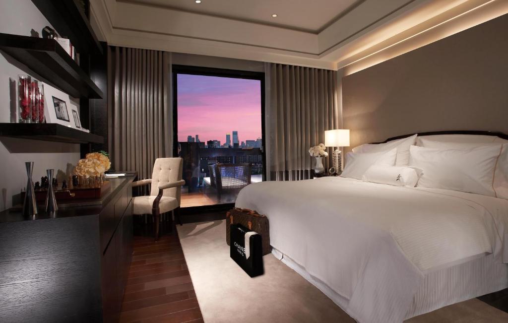 a bedroom with a bed and a desk and a window at Leofoo Residences in Taipei