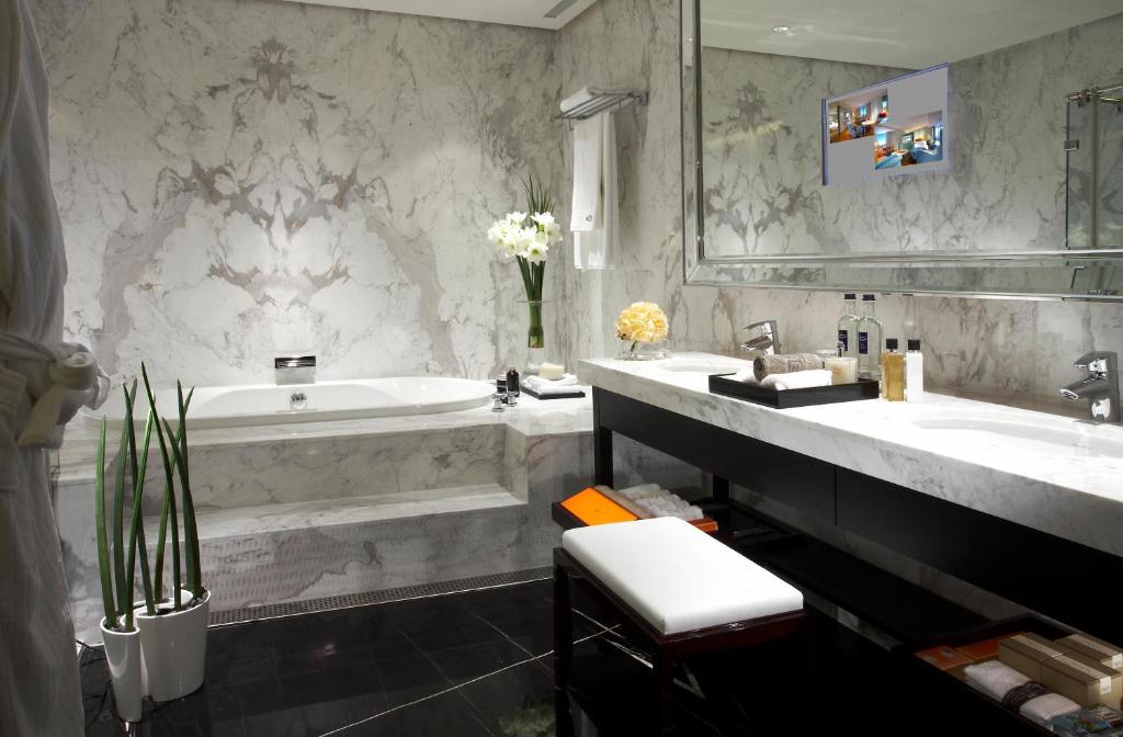 a bathroom with a tub and a sink and a bath tub at Leofoo Residences in Taipei