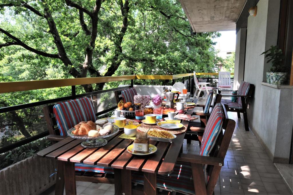 a wooden table with food on a balcony at Sole & Querce Apartments- Bike Friendly with garage in Lanciano