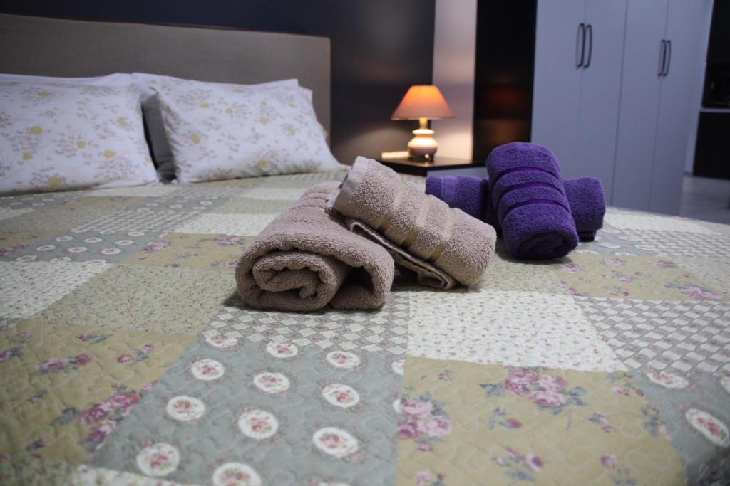 a bedroom with a bed with stuffed animals on it at 3 Brothers III - sense of grey in Tríkala