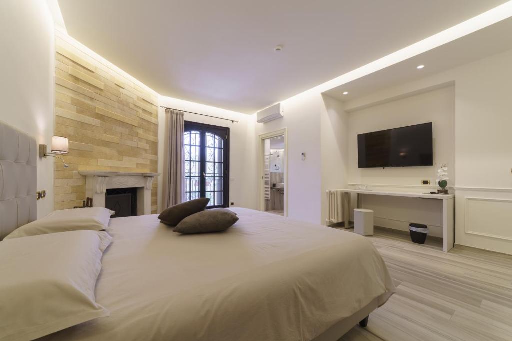 Postel nebo postele na pokoji v ubytování Caffetteria Luca Suite & Rooms