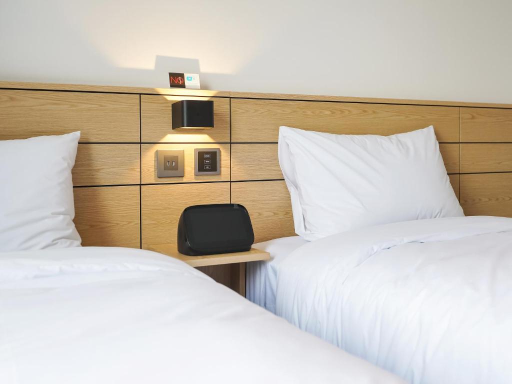 Postel nebo postele na pokoji v ubytování Henn na Hotel Seoul Myeongdong