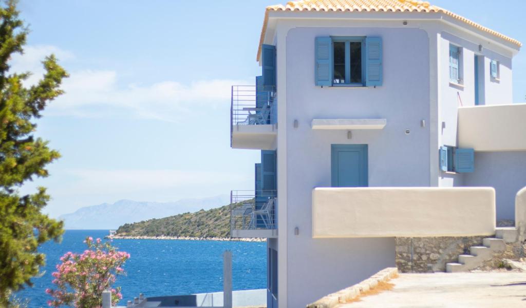 a blue building with a view of the ocean at Akasha Suite IV in Vathi