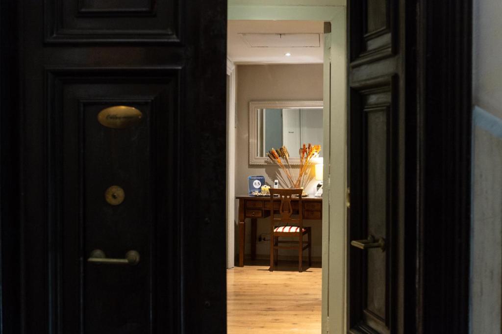 a hallway with a black door and a desk at Residenza Ottaviani Roma in Rome