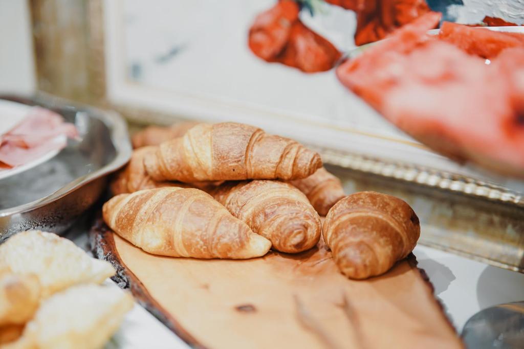 a bunch of croissants and bread on a cutting board at Lot Boutique Hotel by Hotels and Preference in Tirana