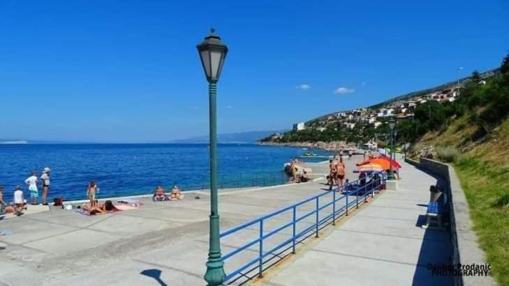a street light next to a beach with people on it at Dalibor in Senj