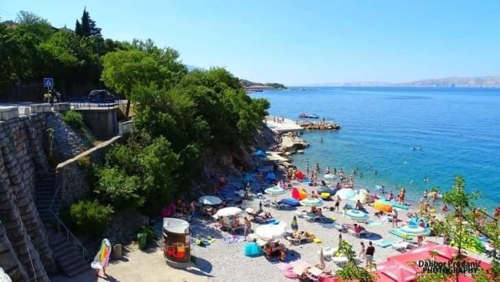 a group of people on a beach near the water at Dalibor in Senj
