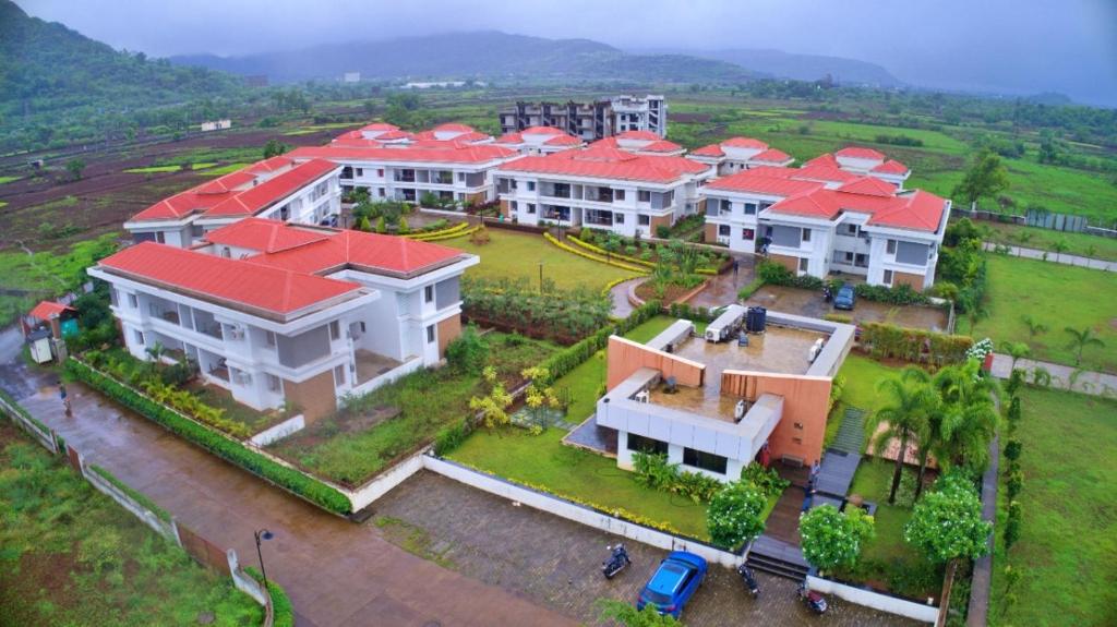 an aerial view of a large house with red roofs at Mizzle Exotica Lonavala in Lonavala