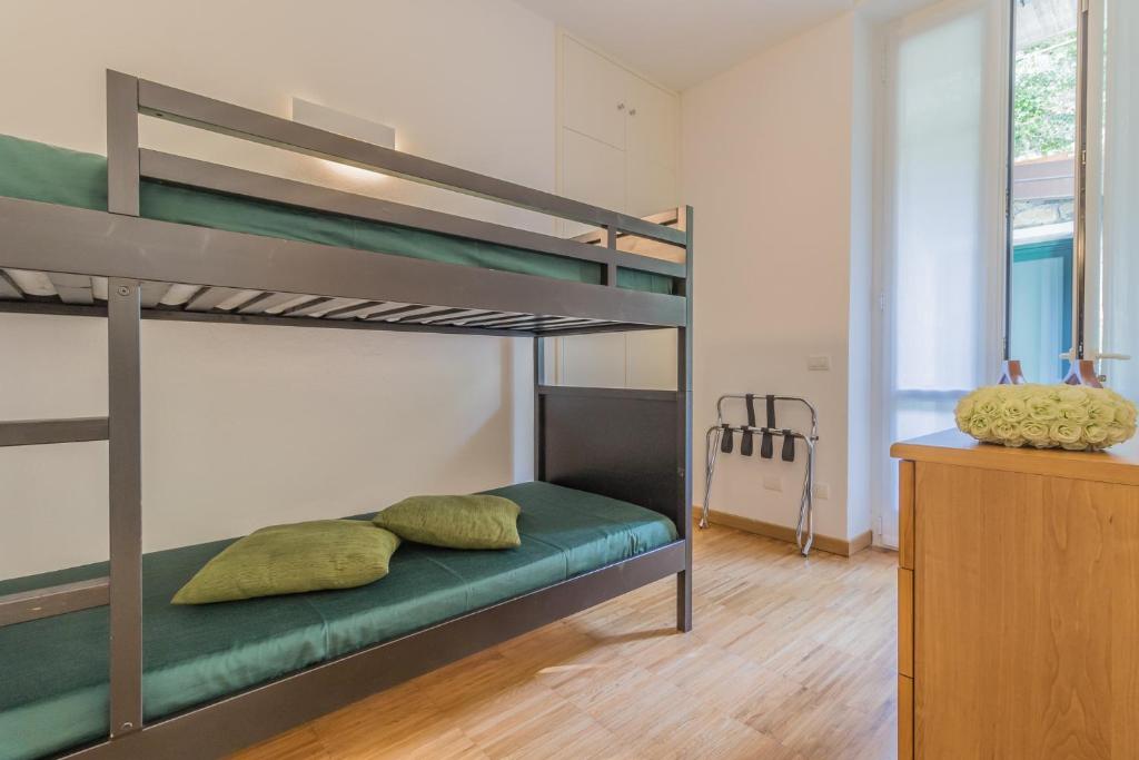 A bed or beds in a room at Varenna Beach Perledo