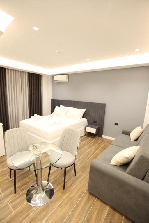 a living room with a bed and a couch and a table at Vila Neli in Ksamil