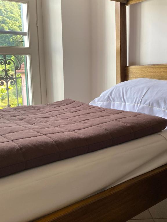 A bed or beds in a room at Ostello Voltaggio