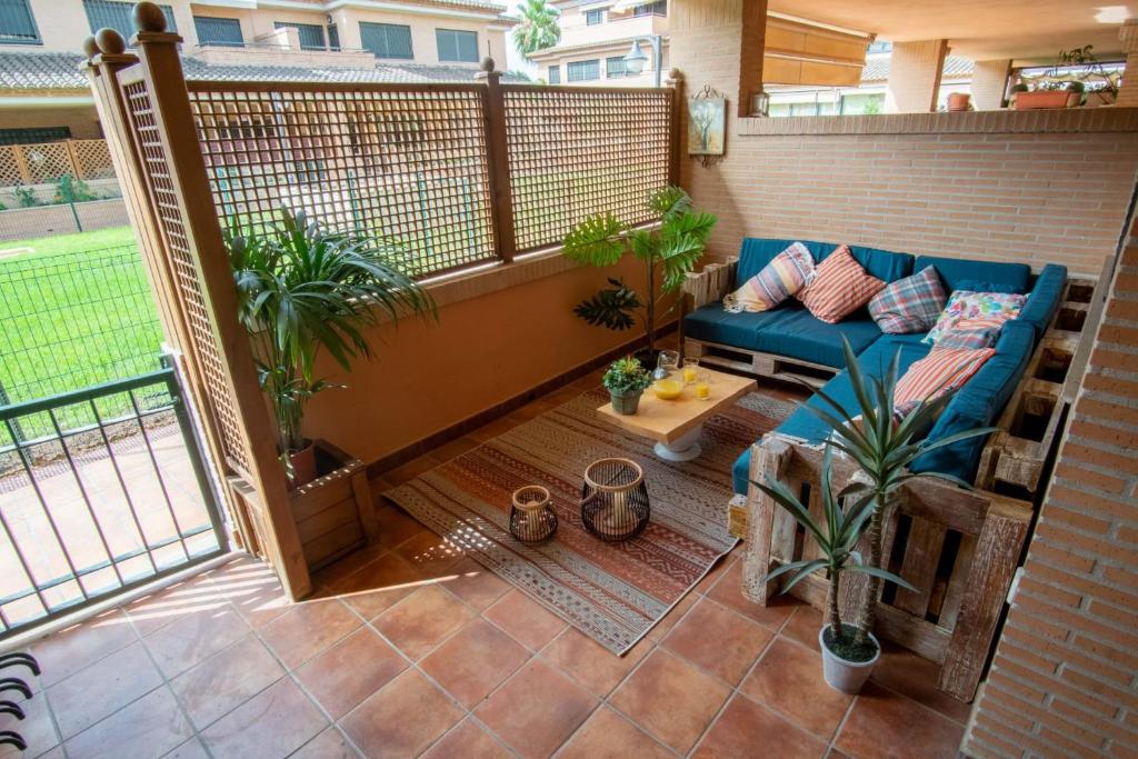 a patio with a blue couch on a balcony at Casa MUNDOVALENCIA in Valencia