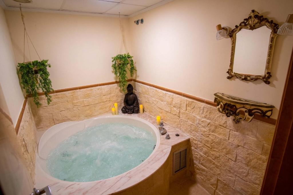 a bathroom with a jacuzzi tub in a room at Casa MUNDOVALENCIA in Valencia