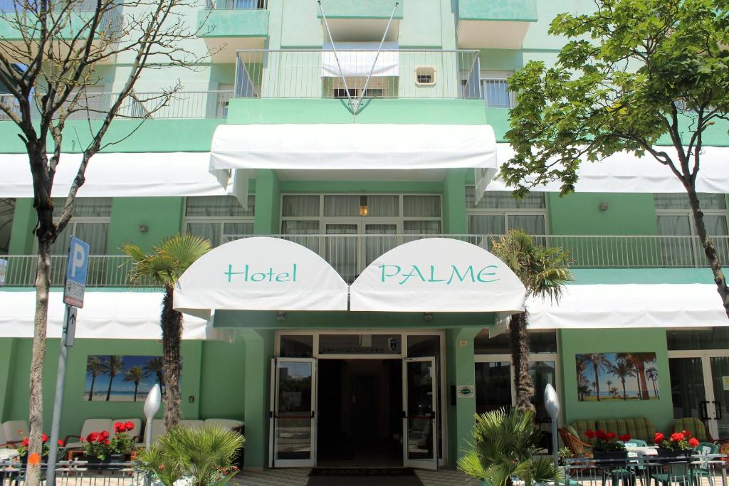 a hotel palaise in front of a building at Hotel Palme Park &amp; Beach included in Lido di Jesolo