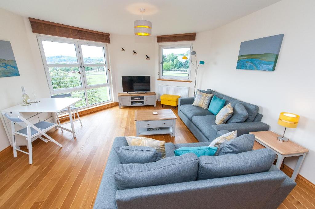 a living room with a couch and a table at Lazy Puffin in Stonehaven