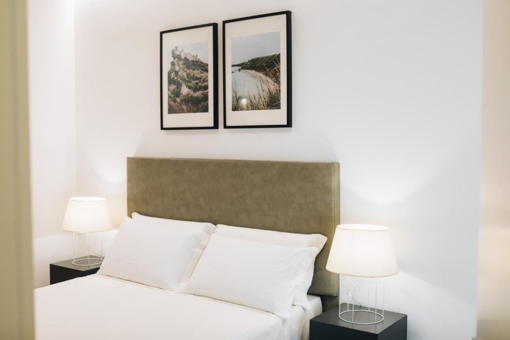 Łóżko lub łóżka w pokoju w obiekcie Centoquindici Rooms & Suite