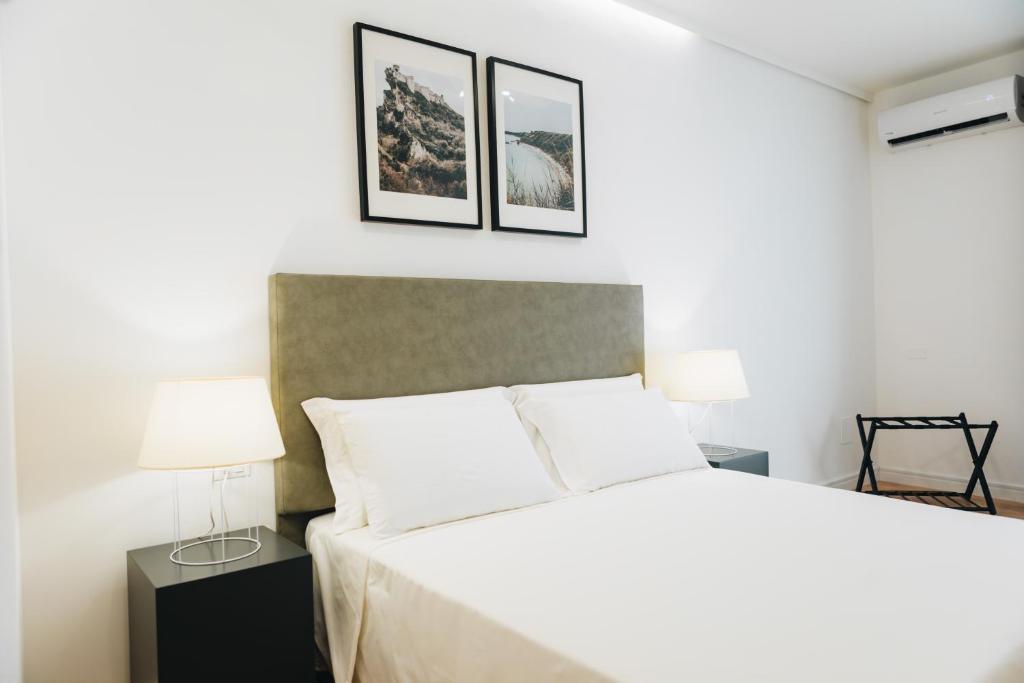 Łóżko lub łóżka w pokoju w obiekcie Centoquindici Rooms & Suite
