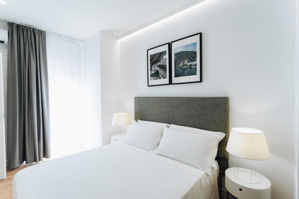 Łóżko lub łóżka w pokoju w obiekcie Centoquindici Rooms & Suite