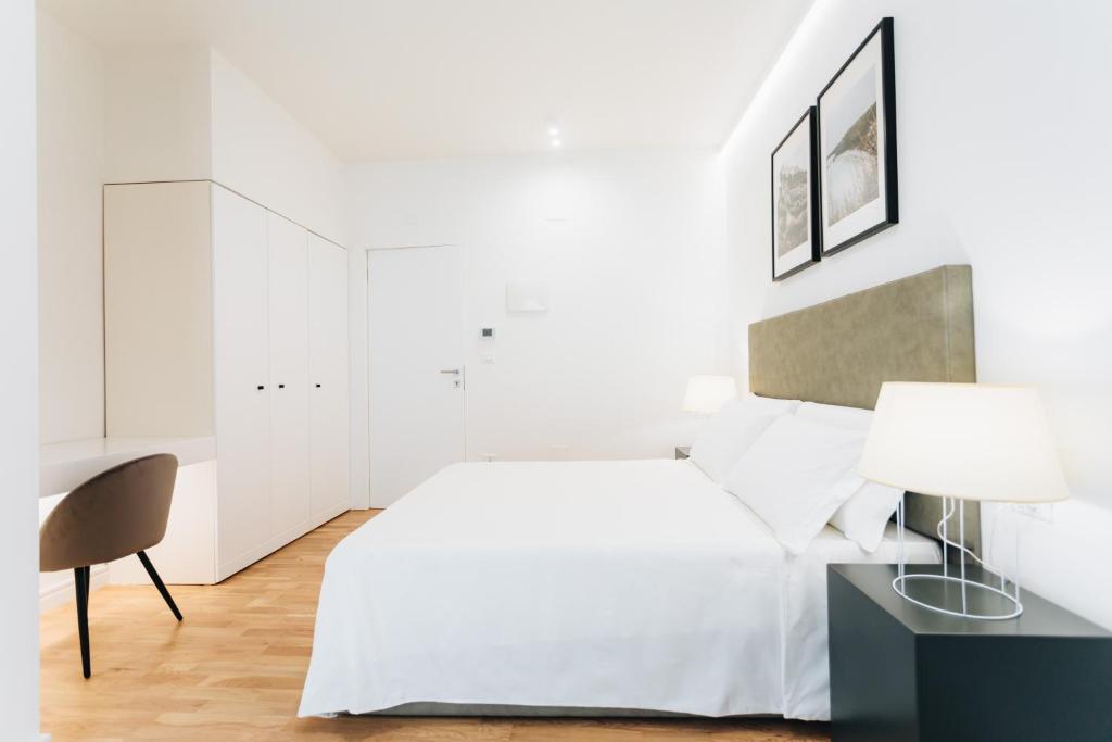 Łóżko lub łóżka w pokoju w obiekcie Centoquindici Rooms & Suite
