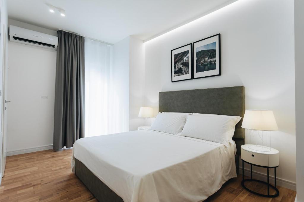 Łóżko lub łóżka w pokoju w obiekcie Centoquindici Rooms & Suite