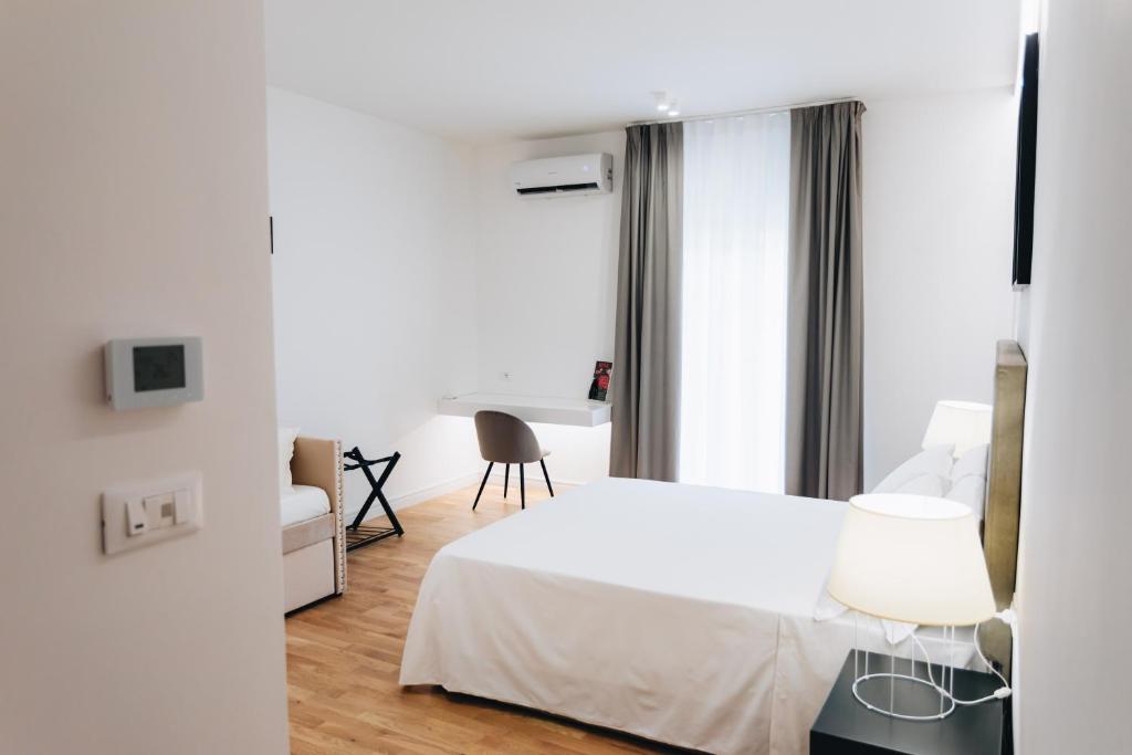 Łóżko lub łóżka w pokoju w obiekcie Centoquindici Rooms & Suite