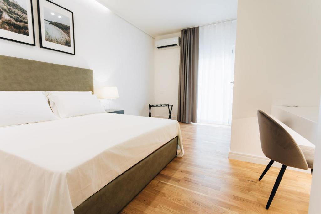 Łóżko lub łóżka w pokoju w obiekcie Centoquindici Rooms & Suite