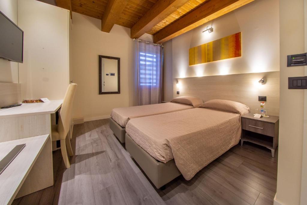 Posteľ alebo postele v izbe v ubytovaní Hotel Regio