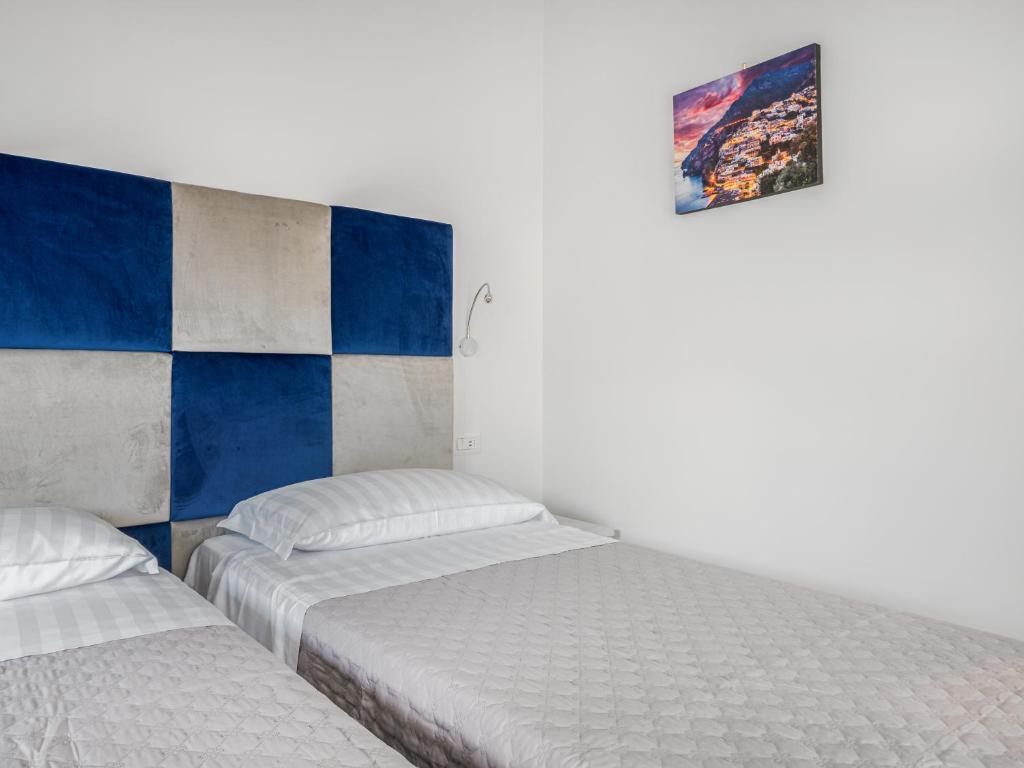 Posteľ alebo postele v izbe v ubytovaní Azzurro Park Suite - De Vivo Realty Sorrento
