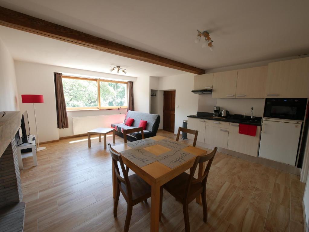 un soggiorno con tavolo e cucina di Appartement T2 40m2 avec extérieur 4 couchages a Saint-Bonnet-en-Champsaur