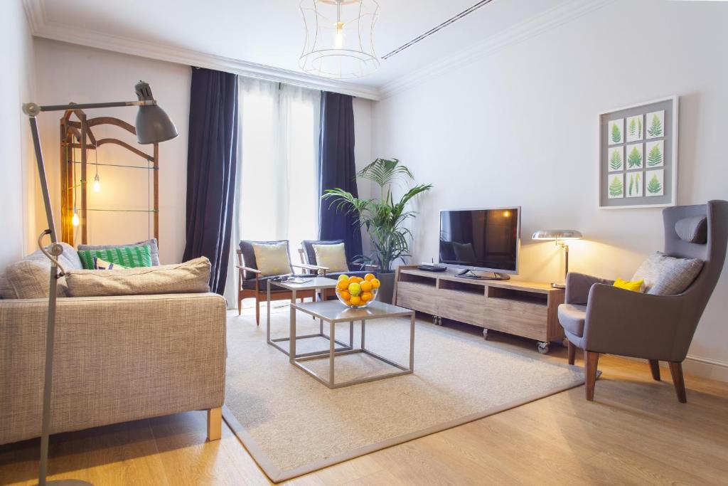 a living room with a couch and a tv at Ola Living Broto in Barcelona