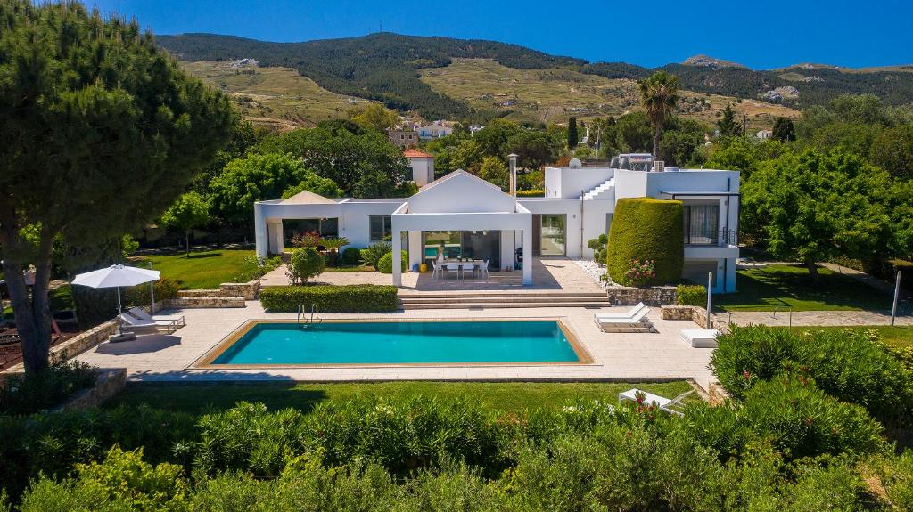 an aerial view of a house with a swimming pool at Villa Syndriani in Paradeísi