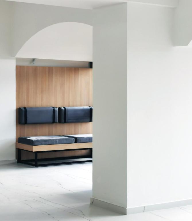 a bed in a room with a white wall at Cavalieri Art Hotel in St. Julianʼs