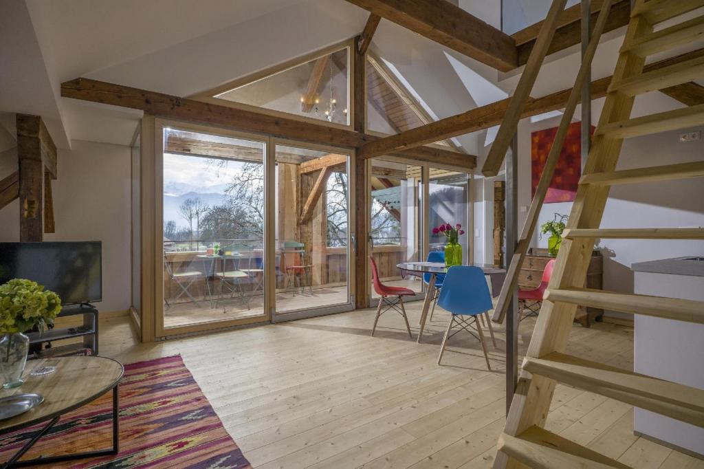 a living room with a large window and a dining room at Villa Kaiser in Auerbach