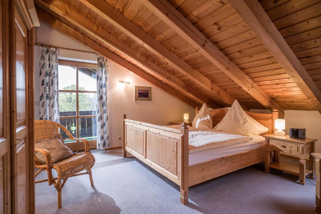 a bedroom with a bed and a chair and a window at Mit einem Traumblick App 37 in Oberaudorf